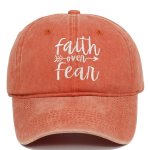 Detailed view of faith over fear white embroidery on vintage orange washed cotton cap