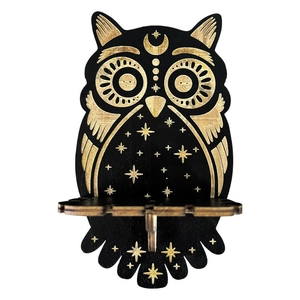 Detailed view of a black owl-shaped wooden shelf with gold moon and star engravings
