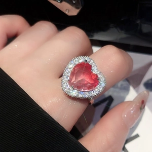 Detailed close-up of heart-shaped pink zircon ring with micro-pave silver setting
