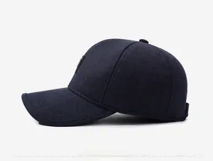 Detail view showing navy blue wool texture and side decorative logo on the baseball cap