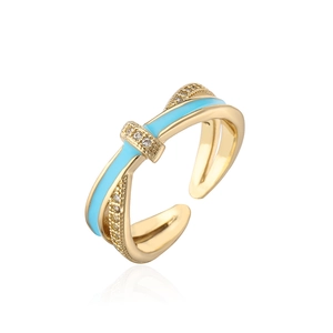 Detail of 18K gold plated crossover ring featuring blue enamel and sparkling zircon stones