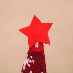 Close-up of a Christmas knitted hat with red felt star and snowflake pattern details