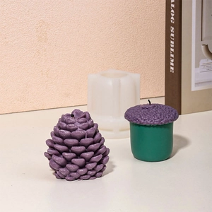 Detailed view of pinecone silicone mold with finished purple pinecone scented candles