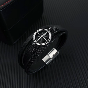 Close-up of woven leather multi-layer men's bracelet with a silver compass magnetic clasp