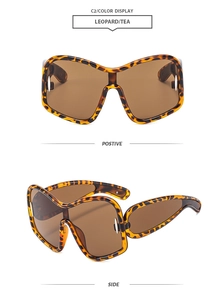 Detail view of Y2K oversized sunglasses in leopard print frame with tea tinted lenses