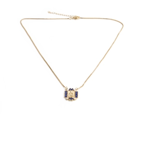 Detail of a vintage golden necklace featuring a religious relief and blue zircon stones
