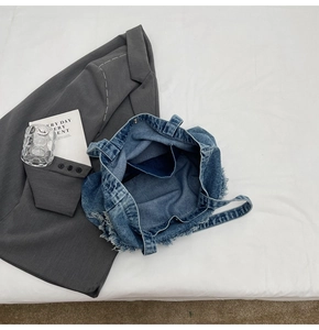Vue de dessus de l'intérieur du sac fourre-tout en jean avec poche et bords effilochés