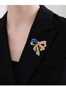 Detail of American flag bow brooch with rhinestones pinned on a black suit lapel