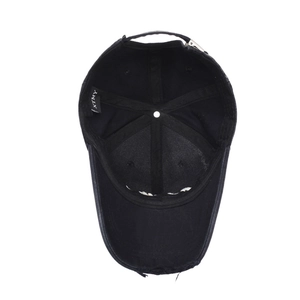 Interior view of vintage black distressed baseball cap with XTMY label and metal buckle