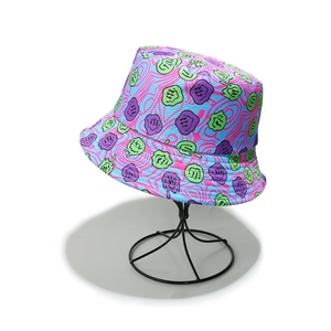 Detail of psychedelic bucket hat with neon melting smiley faces and pink swirl pattern