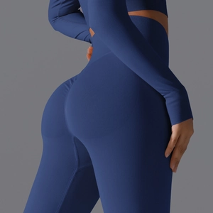 Close-up of seamless dark blue yoga leggings showing high waist and scrunch butt detail