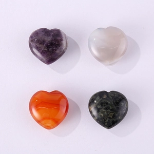 Detailed view of four heart-shaped natural gemstones in purple, white, orange and green