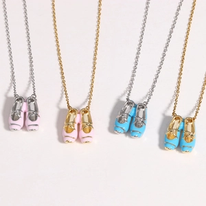 Detail showing four variants of ballet shoe necklaces in gold and silver with pink and blue