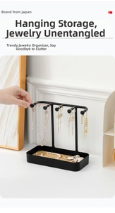 Close-up of black metal jewelry organizer hooks for necklaces and earrings display
