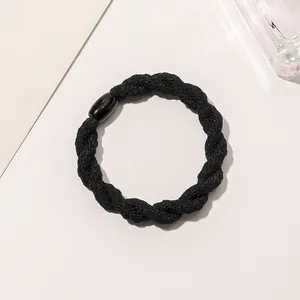 Close-up of black braided elastic hair tie with a sleek polished resin connector piece