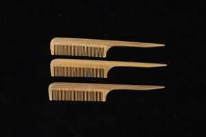 Three natural green sandalwood fine-tooth combs with long pointed handles for hair styling