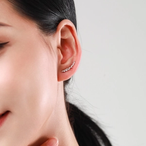 Minimalist S925 sterling silver leaf drop earrings shown on a model for a chic look