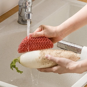 Red silicone vegetable brush for kitchen cleaning with soft bristles for scrubbing radish
