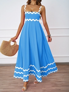 Close-up of elegant sky blue summer dress with white scalloped lace edges and A-line hem