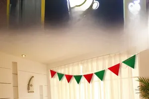 Detail of red and green felt pennant banner hanging by a window for Christmas decoration