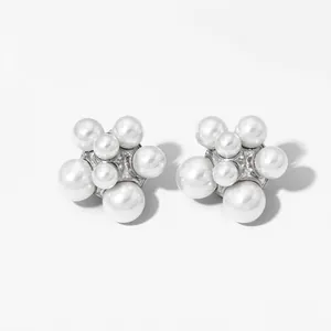 Macro shot of stainless steel stud earrings with scattered cluster pearls in flower shape