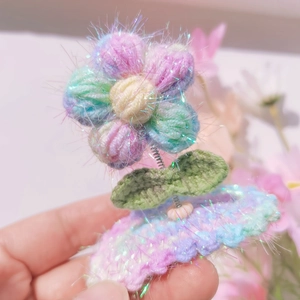 Handmade crochet puff flower hair clip in pastel macaron yarn with sparkling tinsel details