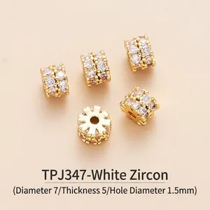 Macro detail of 7mm gold-plated brass cylinder spacer beads with white zircon inlay