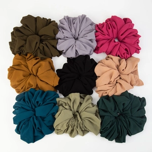 Detail showing a 3x3 grid of nine colorful high-elasticity chiffon fabric scrunchies