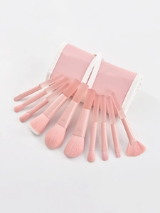 Detailed view of 10-piece peach pink makeup brush set with a matching roll-up storage bag