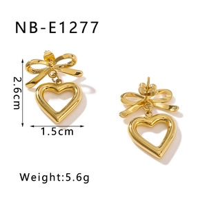 Detail view of golden bow heart earrings showing dimensions 2.6cm and weight 5.6g