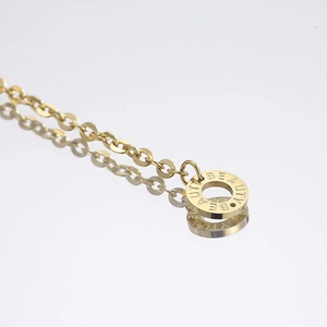 Macro view of gold cat eye stone pendant with Beauty engraving on polished chain