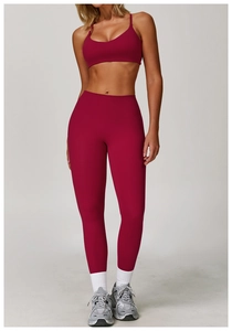 Detailed close-up of berry red high-waisted yoga leggings and seamless sports bra set