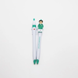 Close-up of white nurse pens with green cartoon doctor clip and 'You are awesome' text