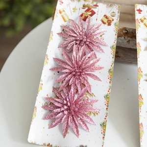 Glittery pink artificial Christmas flowers set on card for holiday tree decorations