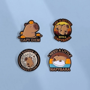 Set of four cartoon capybara enamel pins with playful puns on a blue background