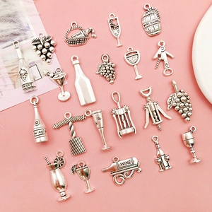 Detailed silver wine-themed charms including grapes, bottles, and glasses on pink backdrop