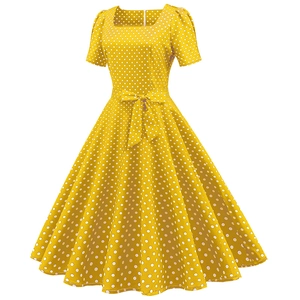 Detail of vintage square neck yellow polka dot dress with waist bow and flared hemline