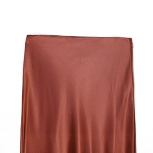 Lustrous copper satin midi skirt featuring lace trim and a hidden side zipper closure