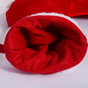 Macro shot of red Christmas stocking with white faux fur trim and interior stitching details