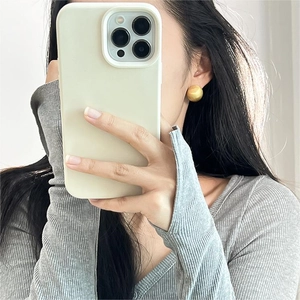 Mirror selfie showing a golden matte sphere stud earring worn on a model for a chic look
