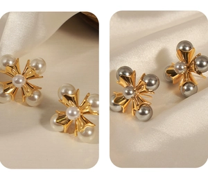 Detail of vintage copper pearl stud earrings in gold and grey windmill flower design