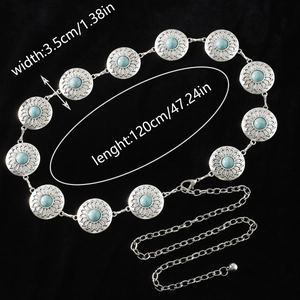 Detail of vintage bohemian waist chain with turquoise stones and sunburst metal links
