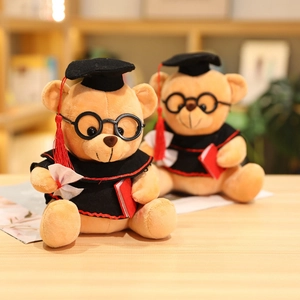 Detail of two graduation teddy bears with gowns, caps, glasses and miniature scrolls
