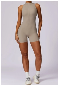 Detailed view of the front zipper and high-neck design on the beige athletic jumpsuit