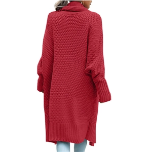 Macro shot of thick red knit texture and drop shoulder design on long cardigan back