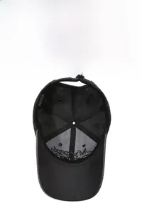 Detail view of cotton baseball cap interior showing 100% cotton label and brass buckle