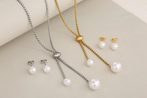 Detail of silver and gold stainless steel jewelry sets with pearls and adjustable chains