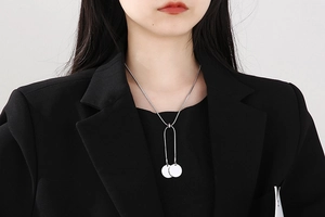 Silver stainless steel snake chain necklace with U-shaped tube and round pendants on model