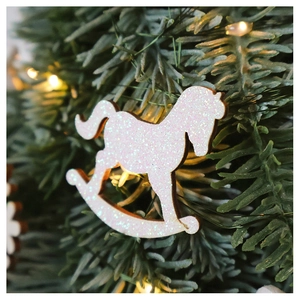Glittering light pink wooden rocking horse hanging ornament on a green Christmas tree