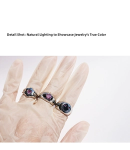 Detailed shot of three silver rings with pink heart and star zircon and a smiley face